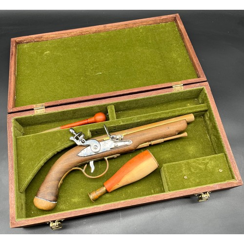 229 - A Reproduction Tower Flint lock pistol with display case. [Hammer jammed]