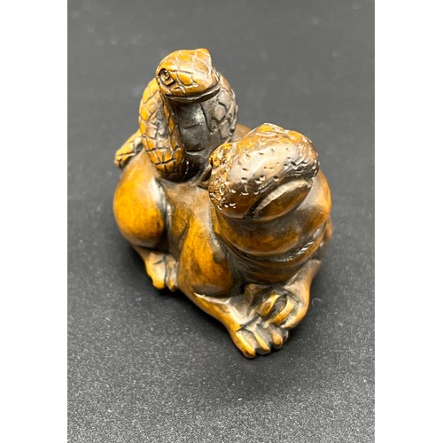 249 - Hand carved Japanese Netsuke sculpture of a hippo resting with a snake on its back. Signed and fitte... 