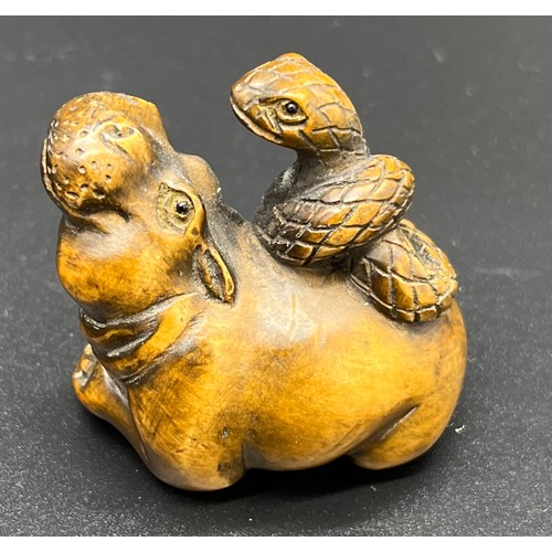 249 - Hand carved Japanese Netsuke sculpture of a hippo resting with a snake on its back. Signed and fitte... 