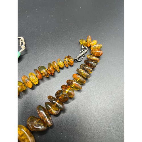 257 - Antique/ Vintage Unique raw amber bead necklace. Beads vary in sizes. Fitted with a white metal clas... 