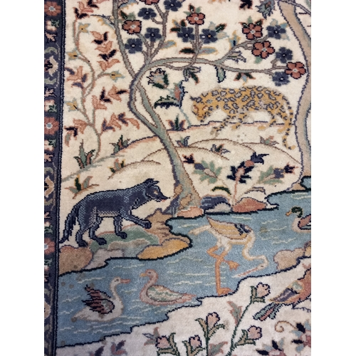 401 - A Quality Asian Wool Rug depicting a river and tree scene with various exotic animals. L 401cm x W 1... 