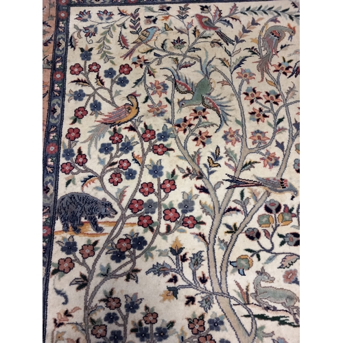 401 - A Quality Asian Wool Rug depicting a river and tree scene with various exotic animals. L 401cm x W 1... 