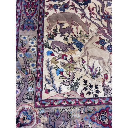 402 - A Quality Asian Wool Rug depicting a wood scene with exotic birds and animals. L 230 X w 138