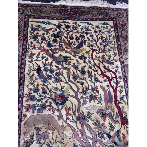 402 - A Quality Asian Wool Rug depicting a wood scene with exotic birds and animals. L 230 X w 138