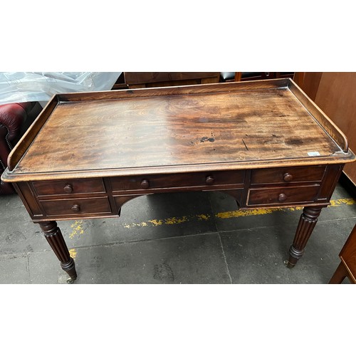 397 - 19th century desk, the gallery top above 
a writing surface and an arrangement of drawers, raised on... 