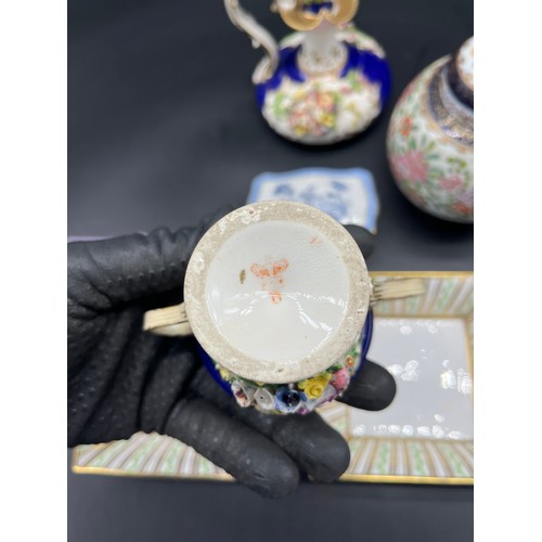 413 - Selection of collectable porcelain to include 19th century Derby two handle cup with raised relief f... 