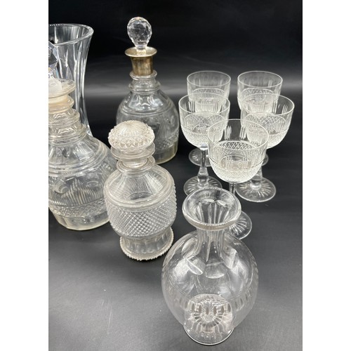 298 - A Collection of crystal decanters and glasses includes silver top decanter, Edinburgh crystal wine g... 