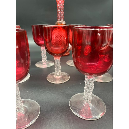 296 - A Collection of 11 Antique cranberry glass and facet cut stem wine glasses, together with cranberry ... 