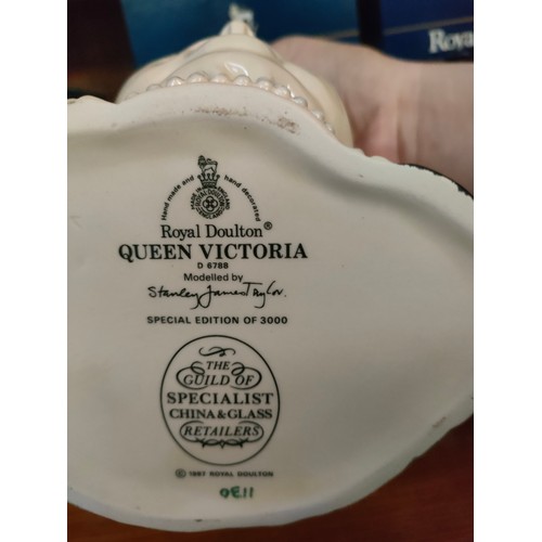 137 - 2 Large Royal Doulton Toby jugs of Queen Victoria in 2 colour variations blue and pink topped with b... 