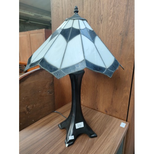 172 - Tiffany style table lamp with shade . Small chip to base.