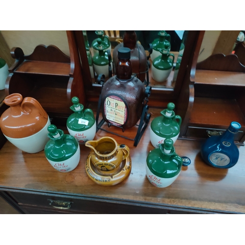 313 - Old Parr's bottle on stand , selection of decanters includes old rarity whisky, monks scotch whisky ... 