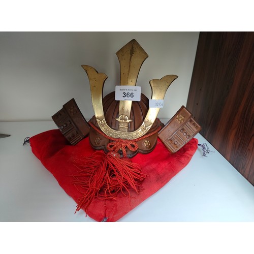 366 - Oriental samurai warrior small display helmet and cushion.