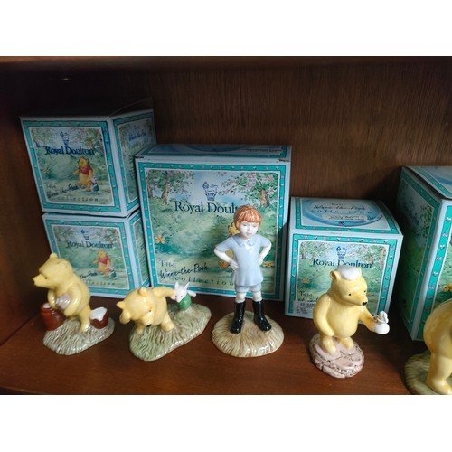 48 - Shelf of Royal Doulton winnie the pooh figures includes Pooh and piglet bank, Christopher Robinson e... 