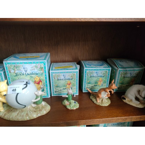 48 - Shelf of Royal Doulton winnie the pooh figures includes Pooh and piglet bank, Christopher Robinson e... 