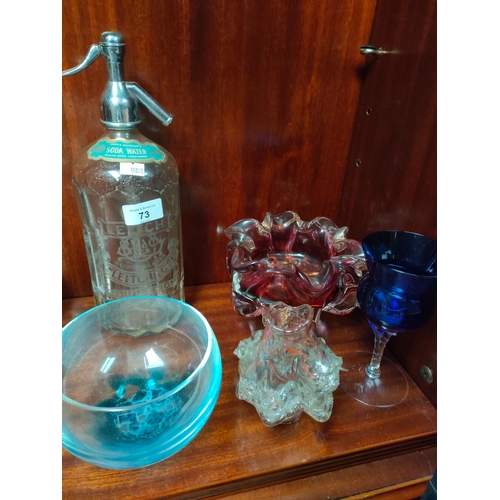 73 - Shelf of art glass ware to include large genie bottle, art glass sculpture vase, Caithness bowl and ... 