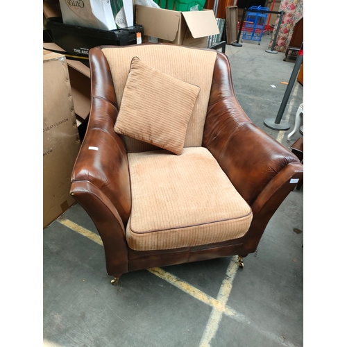 192F - Leather and material arm chair with caster feet .