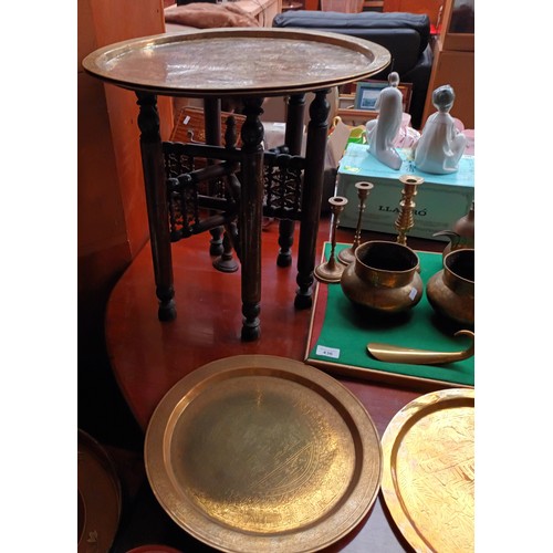 436 - Large collection of brass ware to include chargers, candlesticks, urns & Indian brass top table