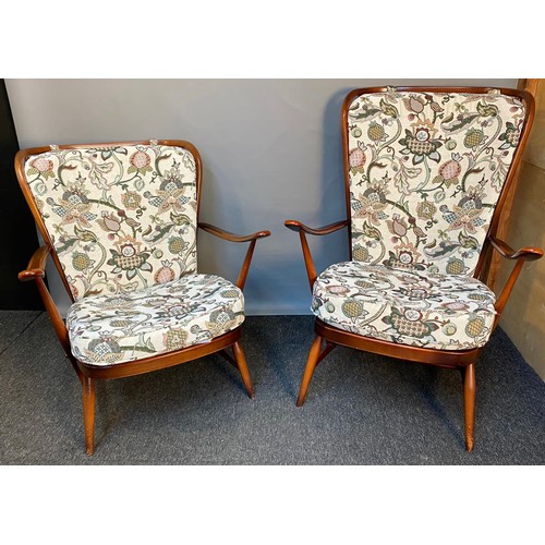 771 - Vintage 'His and Her' Ercol armchairs with original cushions.