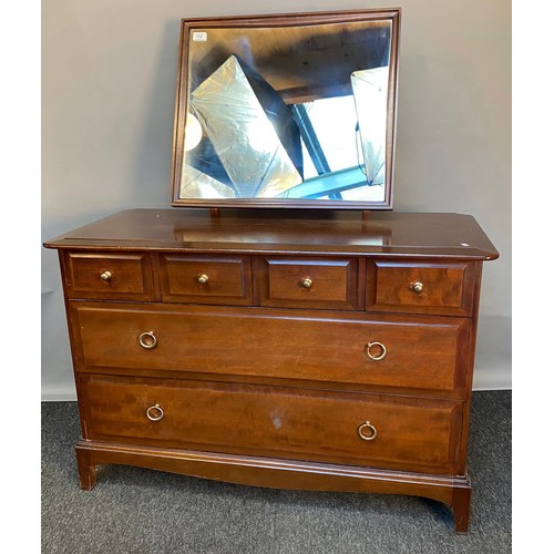 769 - Stag Minstrel chest of drawers, the framed mirror above a chest with an arrangement of four short dr... 