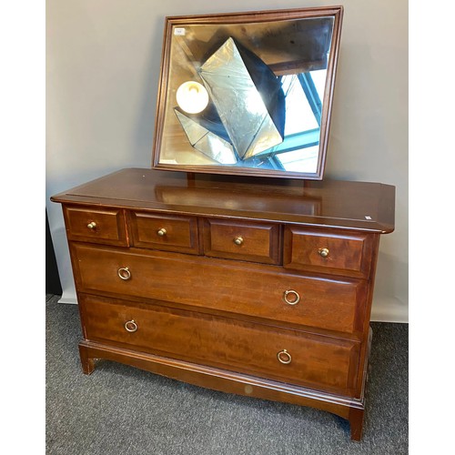 769 - Stag Minstrel chest of drawers, the framed mirror above a chest with an arrangement of four short dr... 