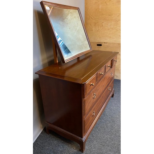 769 - Stag Minstrel chest of drawers, the framed mirror above a chest with an arrangement of four short dr... 