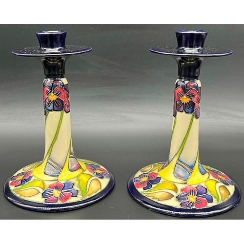 557 - A Pair of Moorcroft candlesticks 'The Dames, Pansy Pattern' Designer Kerry Goodwin, [Dated 2010] [18... 