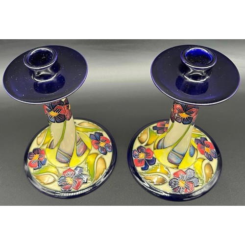 557 - A Pair of Moorcroft candlesticks 'The Dames, Pansy Pattern' Designer Kerry Goodwin, [Dated 2010] [18... 