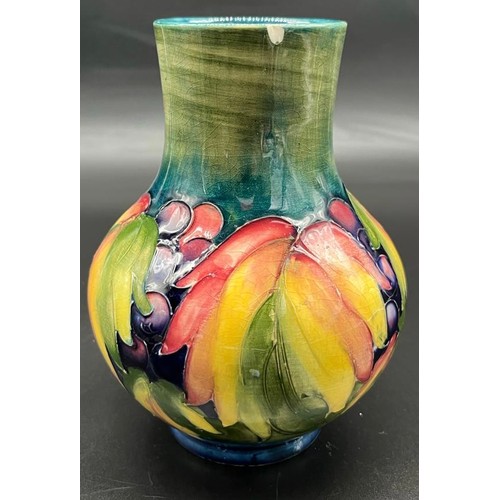 572 - William Moorcroft leaf and berry design Baluster vase. [Small chip to rim] [Impressed factory and H.... 