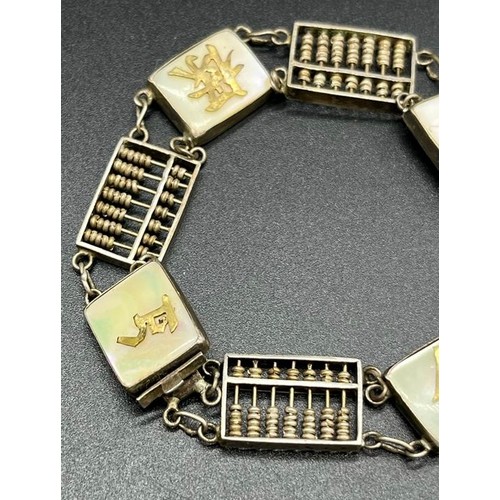 13 - Sterling silver Hong Kong made bracelet. Made up off small abacus, mother of pearl plaques and yello... 