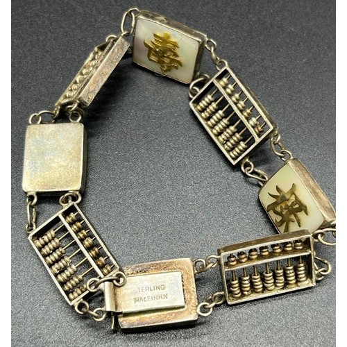 13 - Sterling silver Hong Kong made bracelet. Made up off small abacus, mother of pearl plaques and yello... 