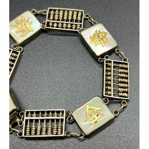 13 - Sterling silver Hong Kong made bracelet. Made up off small abacus, mother of pearl plaques and yello... 