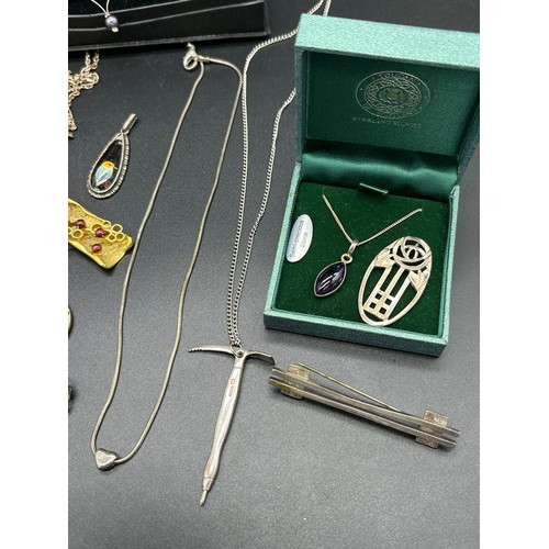 14 - A Collection of silver jewellery to include Sheffield silver pick axe pendant and chain, Charles Hor... 