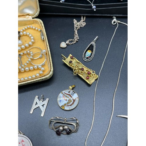 14 - A Collection of silver jewellery to include Sheffield silver pick axe pendant and chain, Charles Hor... 