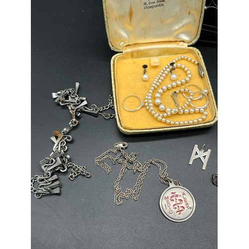 14 - A Collection of silver jewellery to include Sheffield silver pick axe pendant and chain, Charles Hor... 