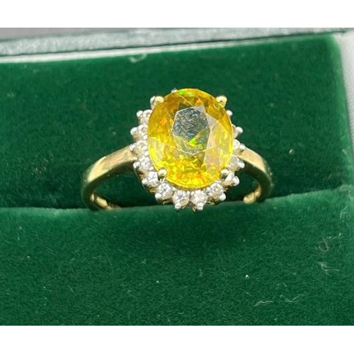 22 - Ladies 10ct yellow gold ring set with a large yellow stone off set by white stones. [Ring size N] [3... 