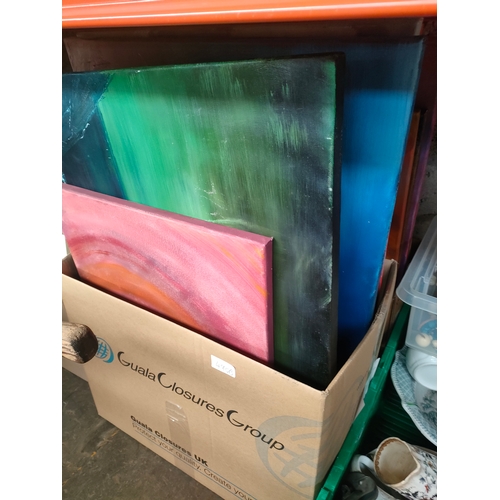 490B - 2 boxes of unframed oil paintings