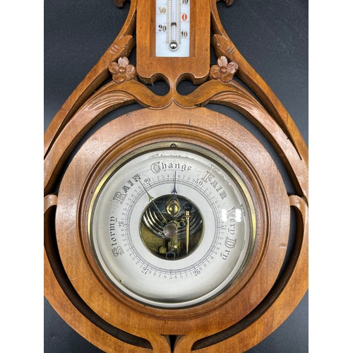 574 - Antique Barometer and thermometer within a hand carved art Nouveau form wood casing. [52cm in length... 