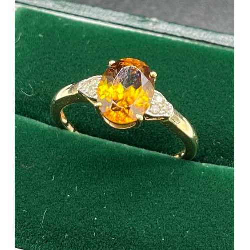 506 - 10ct yellow gold ladies ring set with an orange tourmaline stone off set by diamond shoulders. [2.05... 