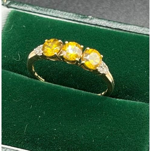 509 - 10ct yellow gold ladies ring set with three round cut yellow tourmalines off set by diamond shoulder... 