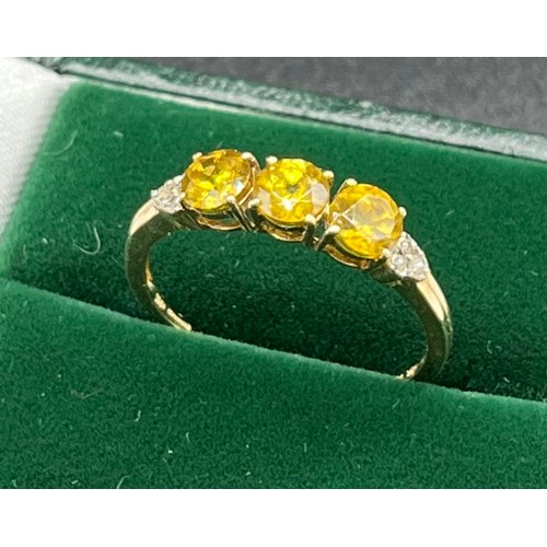 509 - 10ct yellow gold ladies ring set with three round cut yellow tourmalines off set by diamond shoulder... 