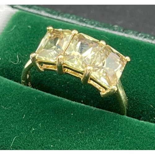 515 - 10ct yellow gold ladies ring set with three emerald cut pale green topaz stones. [Ring size P] [2.81... 