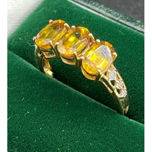 518 - 10ct yellow gold ladies ring set with three oval cut yellow/ orange tourmaline stones off set by dia... 