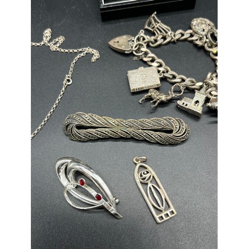 24A - A Selection of silver jewellery to include Gate bracelet with various charms.