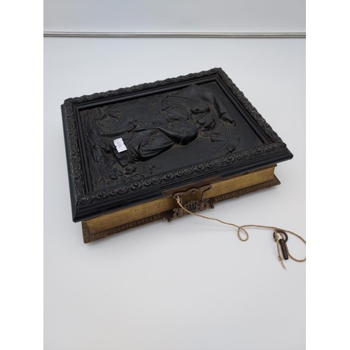 725 - A Victorian photograph album with an in-built musical mechanism [comes with wind up key] finished wi... 