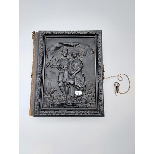 725 - A Victorian photograph album with an in-built musical mechanism [comes with wind up key] finished wi... 