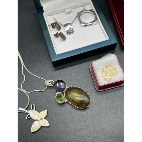 38 - A Selection of silver chains and silver pendants. Includes 9ct gold cross pendant. A Ring, earring a... 