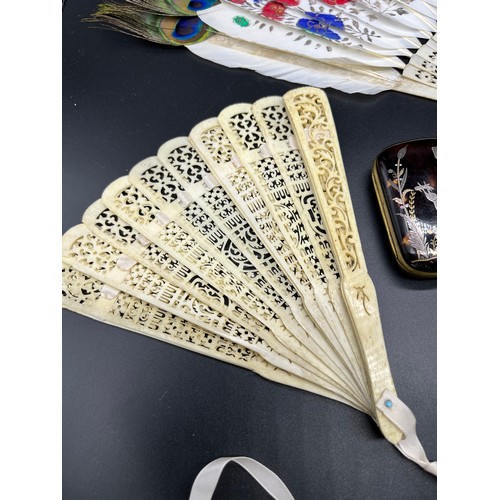 548 - A Lot of four antique Bone hand held fans and a tortoise and silver inlay purse. Fans include Chines... 