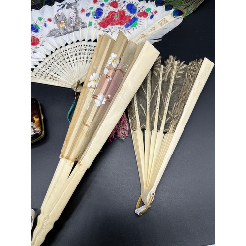 548 - A Lot of four antique Bone hand held fans and a tortoise and silver inlay purse. Fans include Chines... 