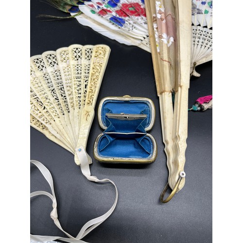 548 - A Lot of four antique Bone hand held fans and a tortoise and silver inlay purse. Fans include Chines... 