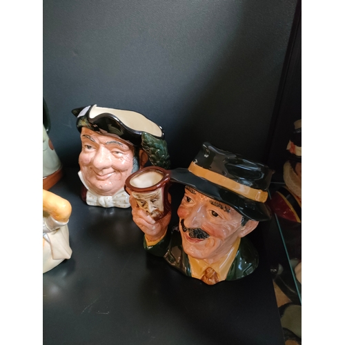 833 - A collection of Royal doulton Toby jugs includes the collector Toby jug , lumberjack, etc